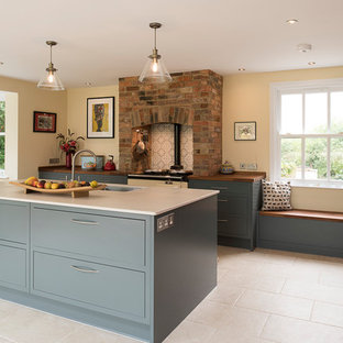 Photo of a mid-sized contemporary l-shaped open plan kitchen in Kent with flat-panel cabinets, grey cabinets, quartzite benchtops, porcelain floors, with island, beige floor, brown benchtop, an undermount sink and ceramic splashback.