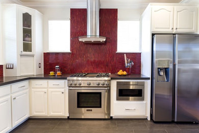 Example of a transitional u-shaped porcelain tile and gray floor kitchen design in San Francisco with white cabinets, quartz countertops, red backsplash, stainless steel appliances, matchstick tile backsplash and gray countertops