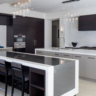 Design ideas for a large contemporary l-shaped kitchen in Orlando with flat-panel cabinets, quartz benchtops, white splashback, porcelain floors, multiple islands, an undermount sink, dark wood cabinets, stainless steel appliances and beige floor.