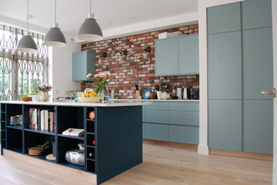 Photo of a contemporary kitchen/diner in Other with flat-panel cabinets and an island.