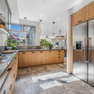 Photo of an asian u-shaped separate kitchen in Perth with flat-panel cabinets, medium wood cabinets, stainless steel appliances, no island, beige floor and grey benchtop.