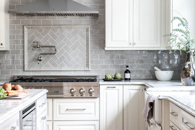Inspiration for a transitional l-shaped open concept kitchen remodel in Boston with raised-panel cabinets, distressed cabinets, an island, a farmhouse sink, quartz countertops and ceramic backsplash