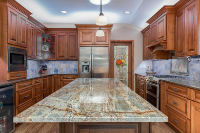 Large transitional u-shaped dark wood floor and brown floor eat-in kitchen photo in Milwaukee with flat-panel cabinets, dark wood cabinets, quartzite countertops, multicolored backsplash, stone tile backsplash, stainless steel appliances and an island
