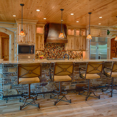 Mountain style kitchen photo in Other with raised-panel cabinets, medium tone wood cabinets, multicolored backsplash and stainless steel appliances