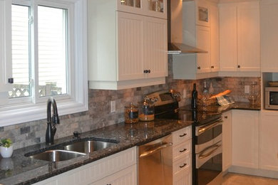 Mid-sized trendy u-shaped porcelain tile and gray floor eat-in kitchen photo in Ottawa with an undermount sink, shaker cabinets, white cabinets, granite countertops, gray backsplash, marble backsplash, stainless steel appliances, a peninsula and blue countertops