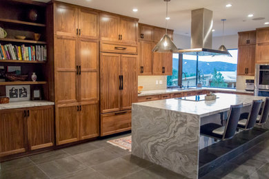 Inspiration for a large transitional l-shaped gray floor open concept kitchen remodel in Salt Lake City with an undermount sink, shaker cabinets, dark wood cabinets, white backsplash, stainless steel appliances, an island and white countertops