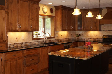 Kitchen - large rustic l-shaped medium tone wood floor kitchen idea in Cleveland with an undermount sink, recessed-panel cabinets, dark wood cabinets, granite countertops and an island