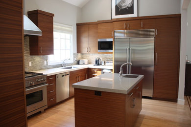 Example of a large trendy u-shaped light wood floor open concept kitchen design in San Francisco with an undermount sink, flat-panel cabinets, medium tone wood cabinets, quartzite countertops, beige backsplash, glass tile backsplash, stainless steel appliances and an island