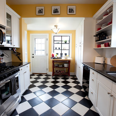 Inspiration for a timeless multicolored floor enclosed kitchen remodel in Omaha with an undermount sink, shaker cabinets, white cabinets, white backsplash, subway tile backsplash and stainless steel appliances