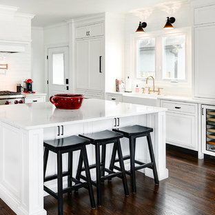 Large transitional eat-in kitchen appliance - Eat-in kitchen - large transitional l-shaped dark wood floor and brown floor eat-in kitchen idea in Jacksonville with a farmhouse sink, white cabinets, quartz countertops, white backsplash, ceramic backsplash, an island, shaker cabinets, paneled appliances and white countertops