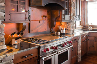 Rustic l-shaped kitchen in Denver with a submerged sink, dark wood cabinets, granite worktops, brown splashback, metal splashback, stainless steel appliances and shaker cabinets.
