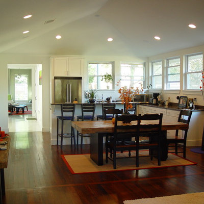 Open concept kitchen - traditional l-shaped open concept kitchen idea in Austin with white cabinets and stainless steel appliances