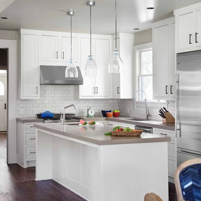 Kitchen - transitional l-shaped kitchen idea in Austin with subway tile backsplash, an undermount sink, recessed-panel cabinets, white cabinets, white backsplash and stainless steel appliances