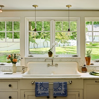 Kitchen - traditional kitchen idea in Burlington with a drop-in sink, marble countertops, white backsplash, stone slab backsplash and white countertops