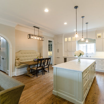 Example of a classic l-shaped eat-in kitchen design in Birmingham with recessed-panel cabinets, white cabinets, white backsplash and stainless steel appliances