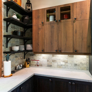 This is an example of a mid-sized country u-shaped eat-in kitchen in Montreal with a farmhouse sink, flat-panel cabinets, medium wood cabinets, concrete benchtops, grey splashback, stone tile splashback, stainless steel appliances, medium hardwood floors, with island, orange floor and grey benchtop.