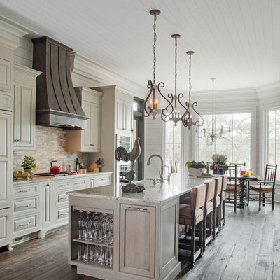 Kitchen - cottage galley dark wood floor and brown floor kitchen idea in Atlanta with a farmhouse sink, raised-panel cabinets, white cabinets, white backsplash, stainless steel appliances and an island