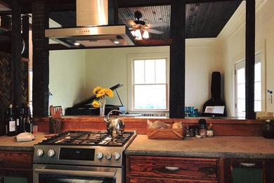 Photo of a small industrial u-shaped enclosed kitchen in Other with recessed-panel cabinets, medium wood cabinets, concrete worktops, beige splashback, ceramic splashback, stainless steel appliances, no island and a submerged sink.