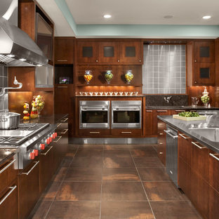 Photo of a contemporary l-shaped kitchen in Cleveland with an integrated sink, flat-panel cabinets, medium wood cabinets, stainless steel benchtops, metallic splashback, metal splashback, stainless steel appliances and with island.