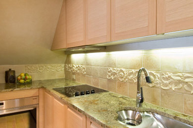 Example of a small eclectic u-shaped enclosed kitchen design in New York with an undermount sink, light wood cabinets, granite countertops, green backsplash, ceramic backsplash and stainless steel appliances
