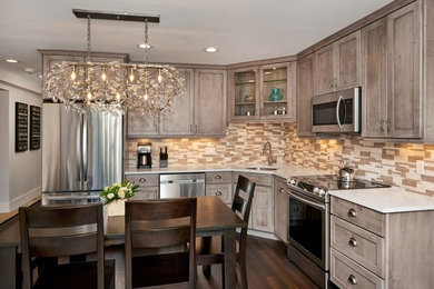 Example of a mid-sized trendy l-shaped dark wood floor and brown floor eat-in kitchen design in Denver with an undermount sink, shaker cabinets, distressed cabinets, beige backsplash, stone tile backsplash, stainless steel appliances and no island