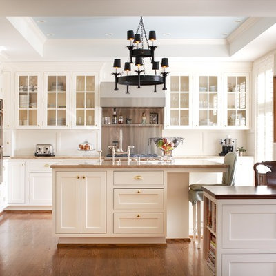 Example of a classic kitchen design in Louisville with glass-front cabinets, white cabinets and paneled appliances