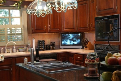 Eat-in kitchen - large contemporary u-shaped medium tone wood floor eat-in kitchen idea in Other with a drop-in sink, raised-panel cabinets, medium tone wood cabinets, granite countertops, beige backsplash, ceramic backsplash, stainless steel appliances and an island