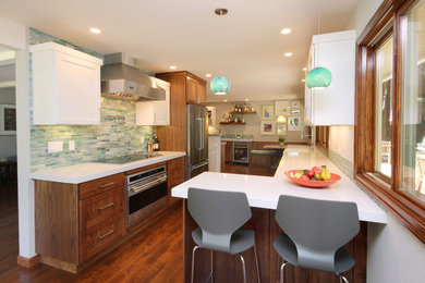 Large trendy u-shaped dark wood floor and brown floor eat-in kitchen photo in San Francisco with a farmhouse sink, shaker cabinets, medium tone wood cabinets, quartz countertops, multicolored backsplash, matchstick tile backsplash, stainless steel appliances and a peninsula
