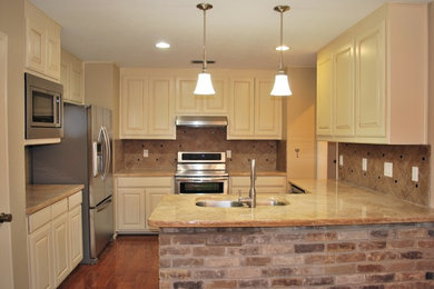 Example of a mid-sized classic medium tone wood floor eat-in kitchen design with white cabinets, granite countertops, ceramic backsplash and stainless steel appliances