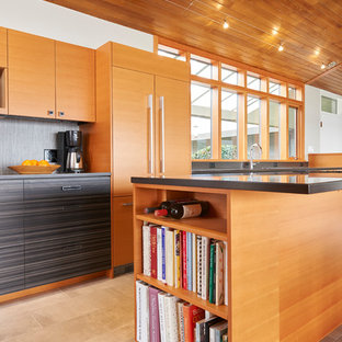 Mid-sized midcentury galley open plan kitchen in Seattle with an undermount sink, flat-panel cabinets, grey cabinets, grey splashback, panelled appliances, cement tiles, with island, beige floor and grey benchtop.