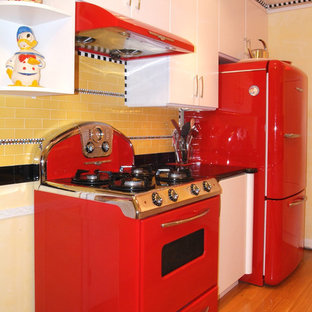 Design ideas for a mid-sized midcentury galley separate kitchen in San Luis Obispo with flat-panel cabinets, white cabinets, granite benchtops, multi-coloured splashback, ceramic splashback, coloured appliances and light hardwood floors.
