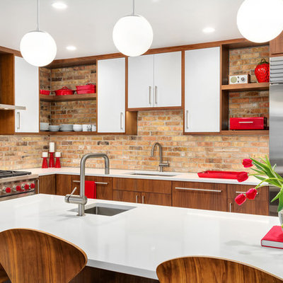 Inspiration for a 1950s l-shaped kitchen remodel in Chicago with an undermount sink, flat-panel cabinets, dark wood cabinets, brown backsplash, brick backsplash, stainless steel appliances, an island, white countertops and quartz countertops
