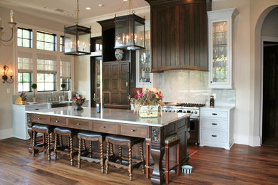 Inspiration for a transitional kitchen remodel in Atlanta with dark wood cabinets, stainless steel appliances and an island