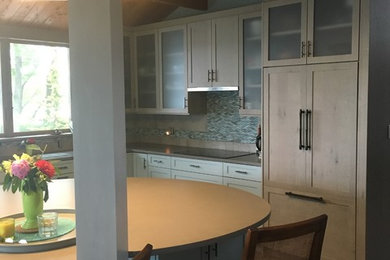 Large transitional l-shaped ceramic tile and beige floor eat-in kitchen photo in New York with an undermount sink, recessed-panel cabinets, white cabinets, quartz countertops, multicolored backsplash, mosaic tile backsplash, paneled appliances and an island