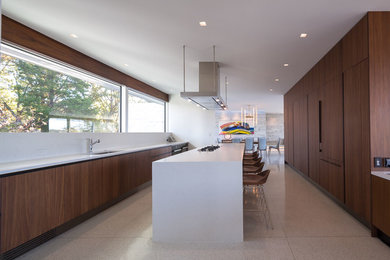 Example of a large minimalist galley terrazzo floor eat-in kitchen design in Richmond with an undermount sink, flat-panel cabinets, medium tone wood cabinets, quartz countertops, white backsplash, stone slab backsplash, black appliances, an island and white countertops