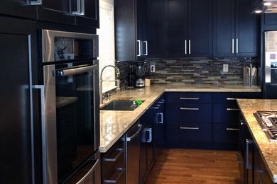Diseño de cocina moderna con puertas de armario de madera en tonos medios, encimera de granito, electrodomésticos de acero inoxidable y suelo de madera en tonos medios