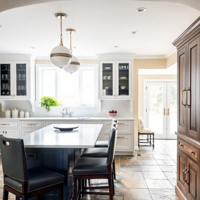 Large elegant u-shaped slate floor and orange floor enclosed kitchen photo in St Louis with quartzite countertops, white backsplash, stone slab backsplash, stainless steel appliances, an island, white countertops, shaker cabinets and white cabinets