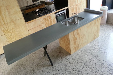 メルボルンにあるコンテンポラリースタイルのおしゃれなダイニングキッチン (ダブルシンク、コンクリートカウンター、ミラータイルのキッチンパネル、アイランドなし) の写真