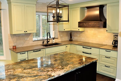 Mediterranean kitchen in Detroit with a single-bowl sink, granite worktops, stainless steel appliances and an island.