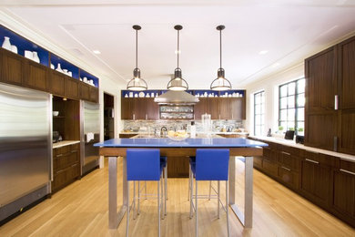 Example of a mid-sized minimalist galley light wood floor eat-in kitchen design in Boston with a drop-in sink, flat-panel cabinets, dark wood cabinets, gray backsplash, glass tile backsplash, stainless steel appliances and an island