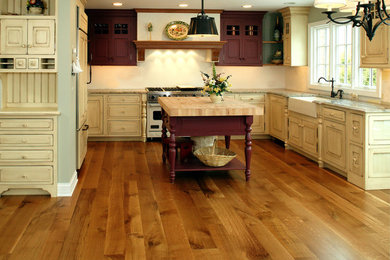 Mid-sized farmhouse medium tone wood floor kitchen photo in Chicago with a farmhouse sink and an island