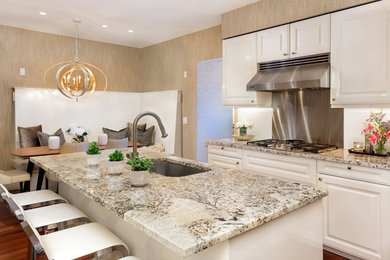 Eat-in kitchen - mid-sized contemporary l-shaped medium tone wood floor eat-in kitchen idea in Philadelphia with a single-bowl sink, raised-panel cabinets, white cabinets, granite countertops, stainless steel appliances and an island