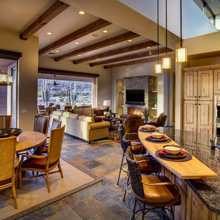 Photo of a large l-shaped open plan kitchen in Phoenix with a double-bowl sink, raised-panel cabinets, medium wood cabinets, granite benchtops, stainless steel appliances, slate floors, with island and multi-coloured floor.