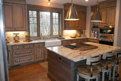 Example of a large mountain style u-shaped dark wood floor and brown floor eat-in kitchen design in Other with a farmhouse sink, recessed-panel cabinets, dark wood cabinets, marble countertops, brown backsplash, marble backsplash, stainless steel appliances and an island