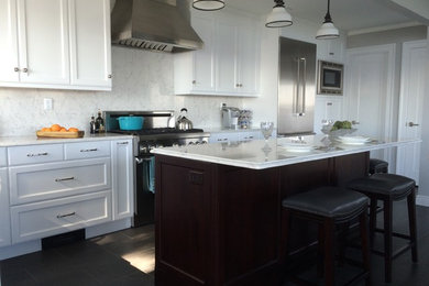 Mid-sized transitional l-shaped ceramic tile and brown floor eat-in kitchen photo in New York with a farmhouse sink, recessed-panel cabinets, white cabinets, quartz countertops, white backsplash, stainless steel appliances, an island and white countertops