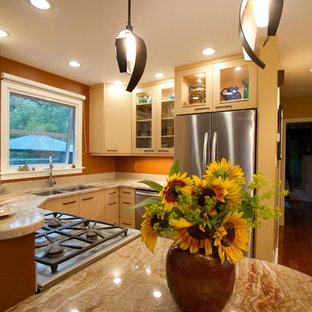 Small eclectic u-shaped eat-in kitchen in Edmonton with an undermount sink, flat-panel cabinets, light wood cabinets, granite benchtops, orange splashback, stone slab splashback, stainless steel appliances, a peninsula and orange benchtop.