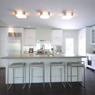 Design ideas for a large midcentury l-shaped open plan kitchen in Grand Rapids with an undermount sink, shaker cabinets, white cabinets, concrete benchtops, stainless steel appliances, dark hardwood floors and with island.