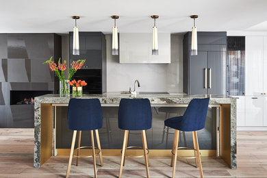 Kitchen - modern kitchen idea in Toronto with beige backsplash and black appliances