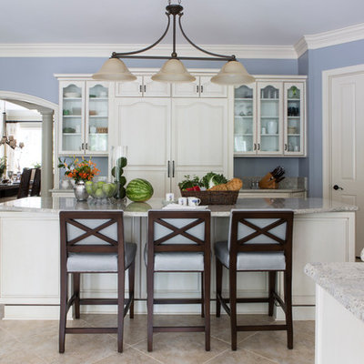 Large elegant ceramic tile and brown floor kitchen photo in DC Metro with raised-panel cabinets, white cabinets, granite countertops, an island and paneled appliances