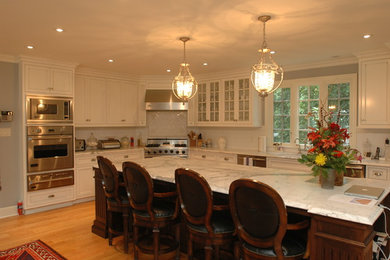 Elegant kitchen photo in Philadelphia with beaded inset cabinets, white cabinets and an island